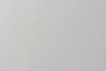 Water drops on white background texture. backdrop glass covered with drops of water. grey bubbles....