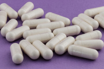 A stack of supplement capsules, dietary supplements, vitamin tablet, nutritional supplements in capsule form.