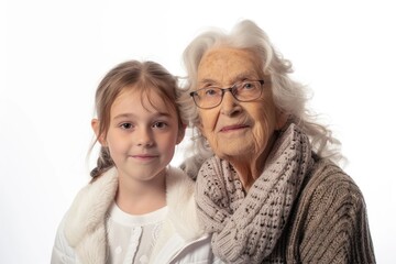 Young girl posing beside old woman in studio