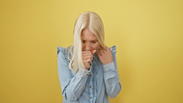Blonde damsel in denim battles bronchitis, coughing woman stands alone, unwell on sunny yellow background