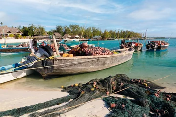 Fotobehang Fishing boats with nets on board waiting to go out and catch fish. Zanzibar Kendwa beach  © janmiko