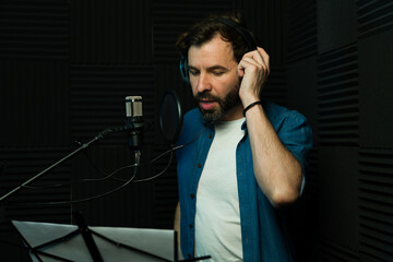Male voice-over artist recording in studio
