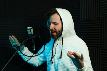 Male vocalist recording in soundproof studio