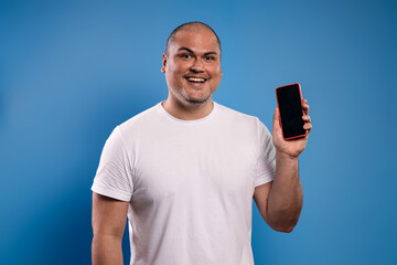 man holding a cell phone and smiling