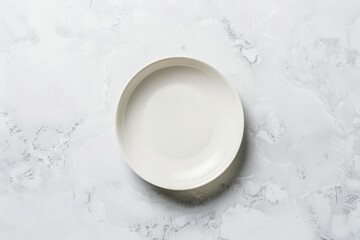 Obraz na płótnie Canvas A top-down view of an empty white porcelain plate placed on a sleek marble counter