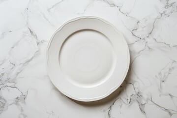 Fototapeta na wymiar A white porcelain plate is placed on top of a sleek marble counter, creating a simple yet elegant composition
