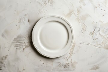 Topdown view of an empty white porcelain plate resting on a sleek marble counter