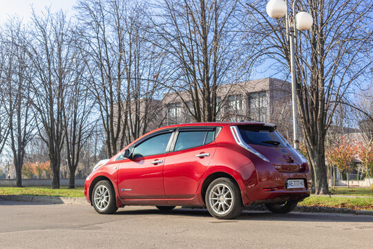Krivoy Rog, Ukraine, November 11, 2023: Photo of red car Nissan Leaf on the street.