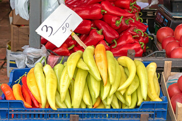 Fresh organic raw peppers in plastic crates sold on market place - 771656169