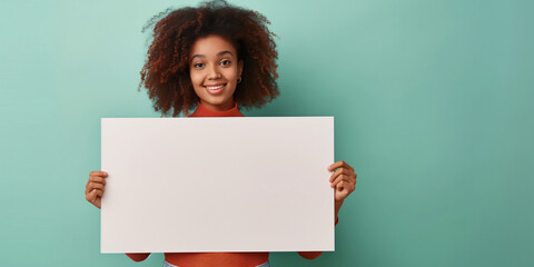 Confident African American Woman Presenting Blank Signboard on Turquoise Background