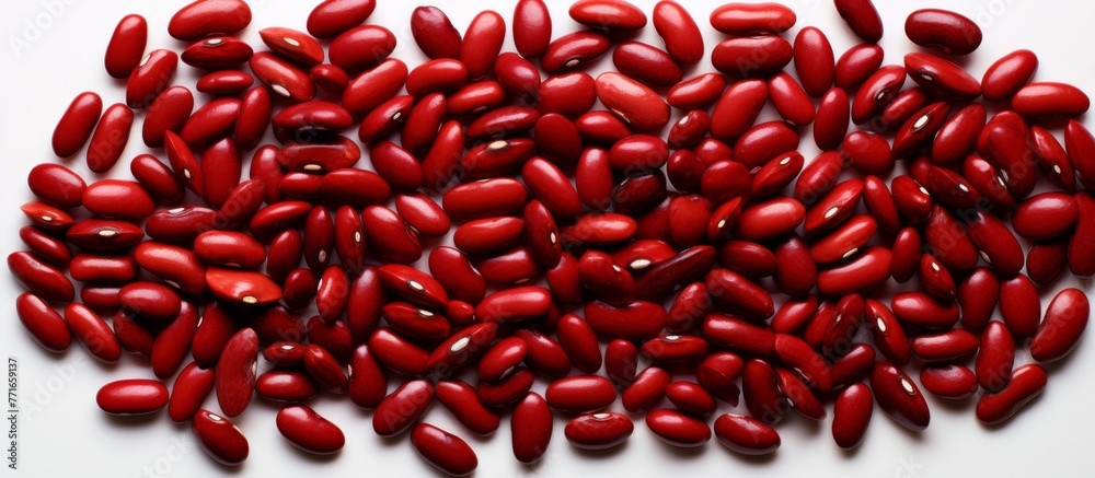 Wall mural a mound of red beans, a staple food and natural ingredient, sits on a white surface. the vibrant pin