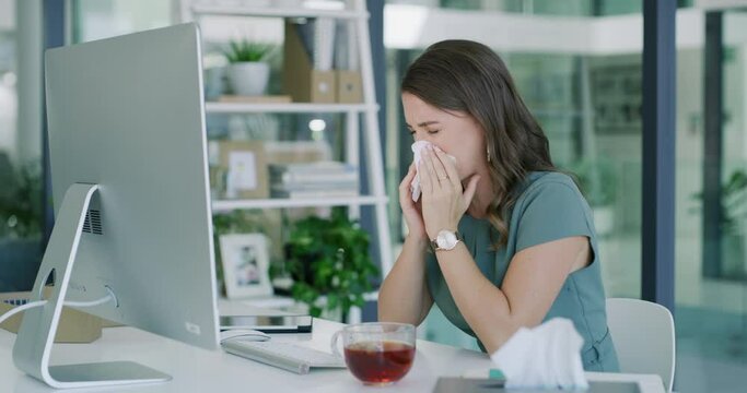 Sick business woman, tissue and blowing nose by computer for virus, infection or disease at office. Female person or employee sneeze with sinus for illness, bacteria or germs by desk at the workplace