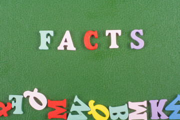 FACTS word on green background composed from colorful abc alphabet block wooden letters, copy space for ad text. Learning english concept.