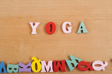 Yoga. composed from colorful abc alphabet block wooden letters.