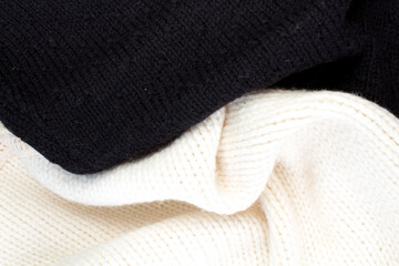 Knitted woolen sweaters. A bunch of knitted winter, autumn clothes, sweaters, knitwear, space for the text.