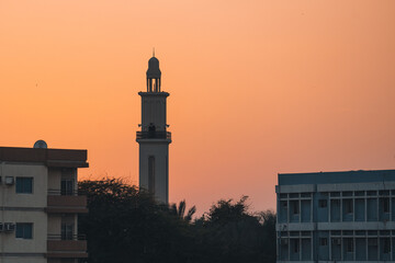 A minaret in Umm Al Quwain, United Arab Emirates, at sunset.
