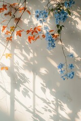 White wall, blue flowers hanging on the branches, sunlight shining through the window onto them, 