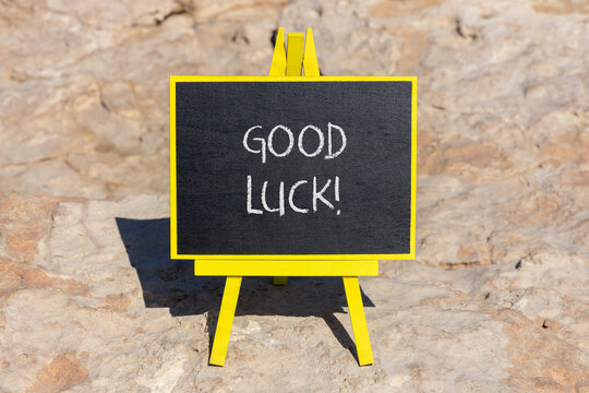 Good luck symbol. Concept words Good luck on beautiful black chalk blackboard. Beautiful sea stone beach background. Business, motivational good luck concept. Copy space.
