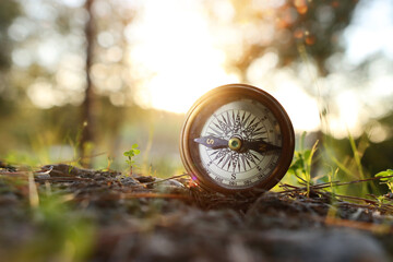 compass on forest ground. concept of finding direction and leadership