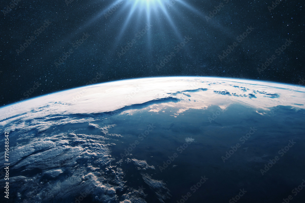 Poster amazing blue planet earth with ocean and clouds with sun light in open space on the starry sky. phot