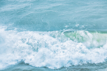 Wave splashing close-up. Crystal clear sea water, in the ocean in San Francisco Bay, blue water, pastel colors.