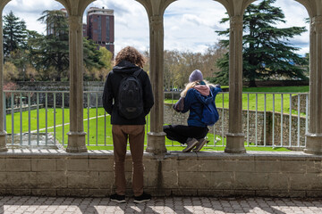 Couple in the park looking at the gardens