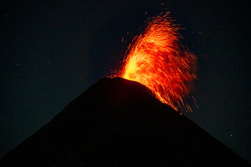 Volcan de Fuego erupting at night seen from Volcan de Acatenango.