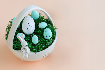 Porcelain basket with cress and Easter eggs on a pastel background - 771691305