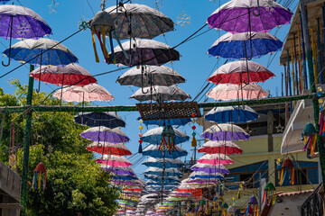 Umbrellas strung above the streets of Lake Atitlan. - obrazy, fototapety, plakaty