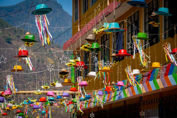 Fototapeta premium Colorful hats strung above the streets of Lake Atitlan.
