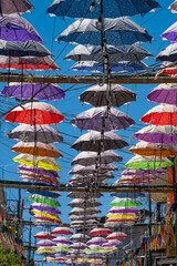 Umbrellas strung above the streets of Lake Atitlan. - obrazy, fototapety, plakaty