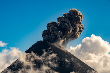 Volcan de Fuego erupting in the daytime as seen from Volcan de Acatenango. - obrazy, fototapety, plakaty