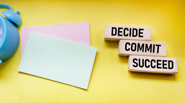 Decide Commit Succeed concept word on wooden blocks. Stickers for writing. The business solution is committed to success.