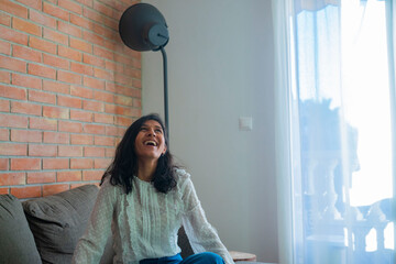Young indian woman looking up