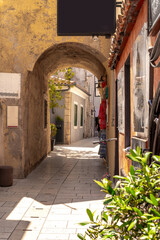 Small passage with round arch in the city centre of Krk. Island of Krk, Croatia