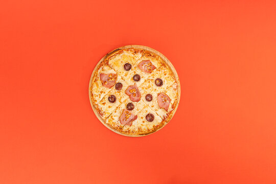 pizza with cheese beacon and olives on orange background