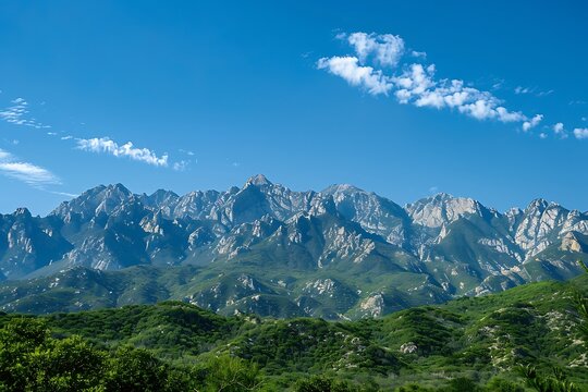 : A majestic mountain range under a clear blue sky