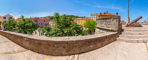 Historical centre with cannon near the main gate in Labin by daylight, Istria, Croatia - obrazy, fototapety, plakaty