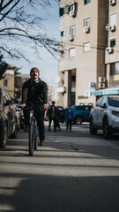 Fototapeta na wymiar A man cycling on a city street among cars, showcasing urban transportation and healthy lifestyle choices.