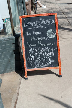 outside chalkboard sign of Little Ghosts, a book store, located at 930 Dundas Street West in Toronto, Canada