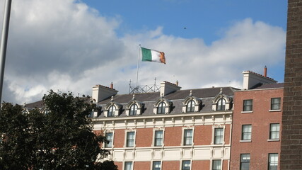 Irish flag flies above a red brick building, Dublin