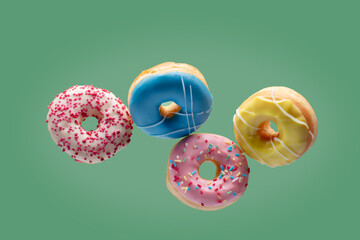 Varius donuts on green pastel background