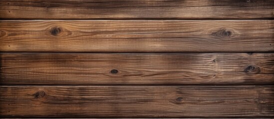 Fototapeta premium A close up of a brown hardwood plank wall with a blurred background, showcasing the beautiful pattern of the wood grain and texture