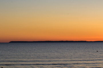 Serene Sunset Over Calm Ocean Horizon