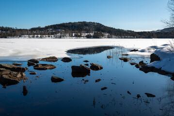Spring is slowly starting to melt the ice on the lakes.