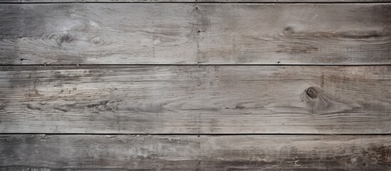 A closeup of a rectangular brown hardwood table with a grey wood grain texture, displaying parallel patterns of tints and shades on the plank flooring - obrazy, fototapety, plakaty