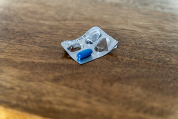 blue medicine pill in a worn container, Mallorca, Balearic Islands, Spain