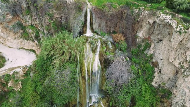 Aerial video of waterfall, travel destination in Turkey, nestled in mountains, surrounded by foliage. Emphasizes waterfall, travel appeal and eco-tourism. Highlights waterfall, travel spot