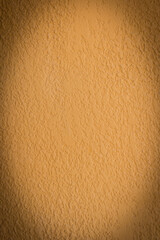 Black vignette vertical photo on the background of plaster wall mustard color stucco molding blank space text empty