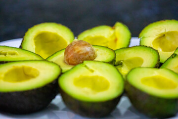 Ripe avocados cut in half in selective focus